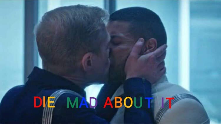 This meme is a screenshot of a scene from the movie "Star Trek: Into Darkness" (2012), where Captain Kirk (played by Chris Pine) and Spock (played by Zachary Quinto) share a passionate kiss. The text "DIE...MAD...ABOUT...IT" is written in a playful, cursive font across the top of the image, but the most notable text is "I...DIE...MAD...ABOUT...IT" in a bold, rainbow-colored font across the bottom of the image, with the words "I...DIE" and "MAD...ABOUT...IT" in a bold, red font, and the words "I...DIE...MAD...ABOUT...IT" in a bold, rainbow-colored font.
